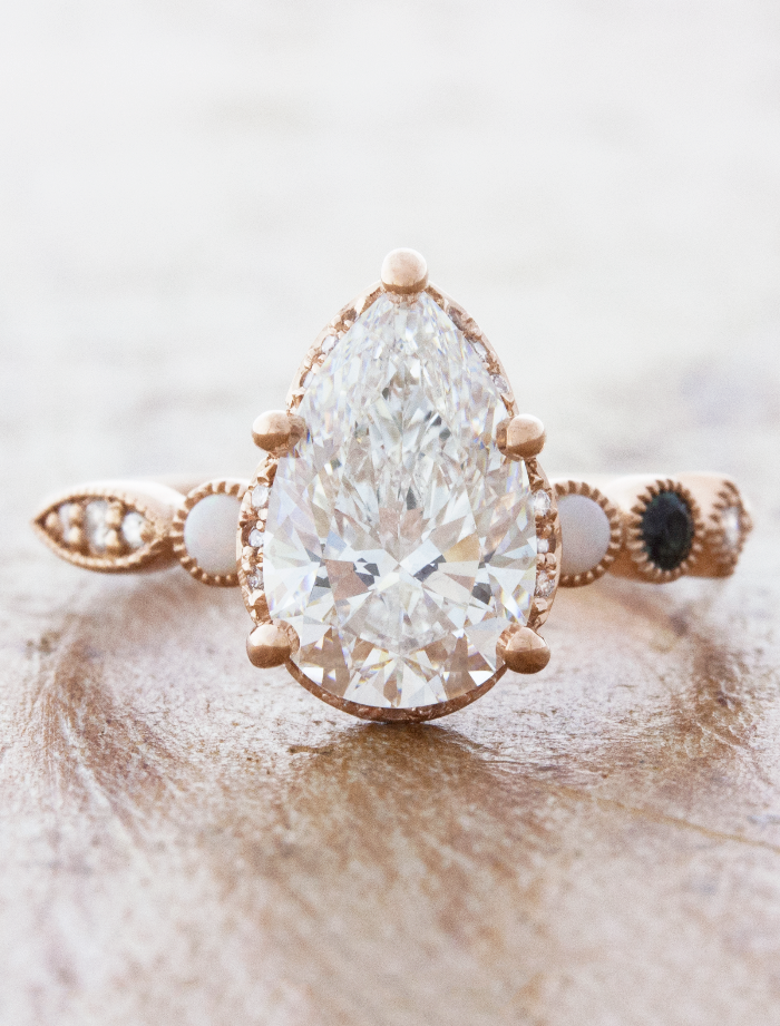 caption:Customized with 2.2ct pear diamond center in 14k rose gold