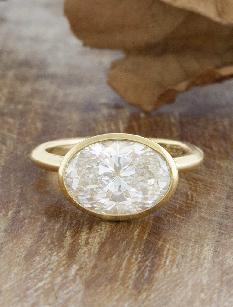 caption:Shown with a 3ct oval set East West in 18k yellow gold