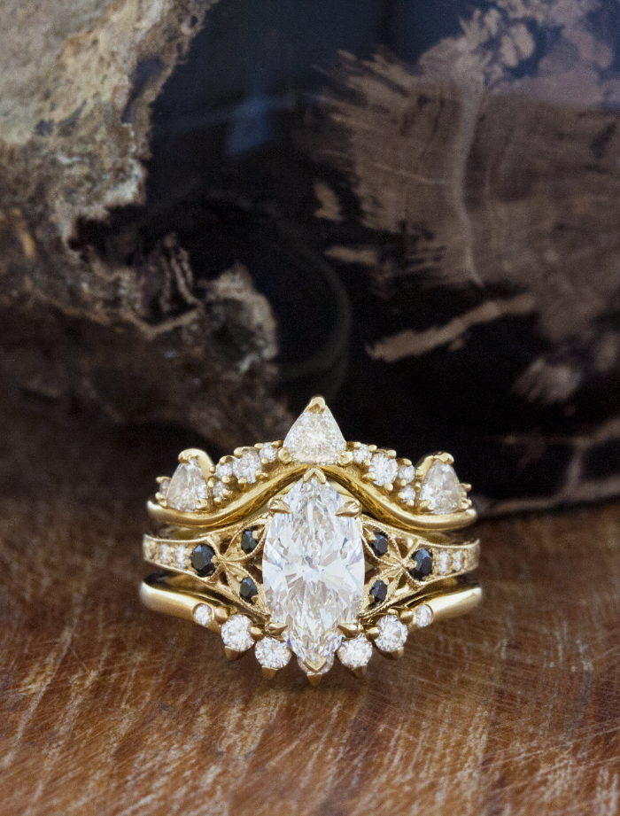 caption:Customized with black diamonds, shown stacked with Tempest and Anu wedding bands