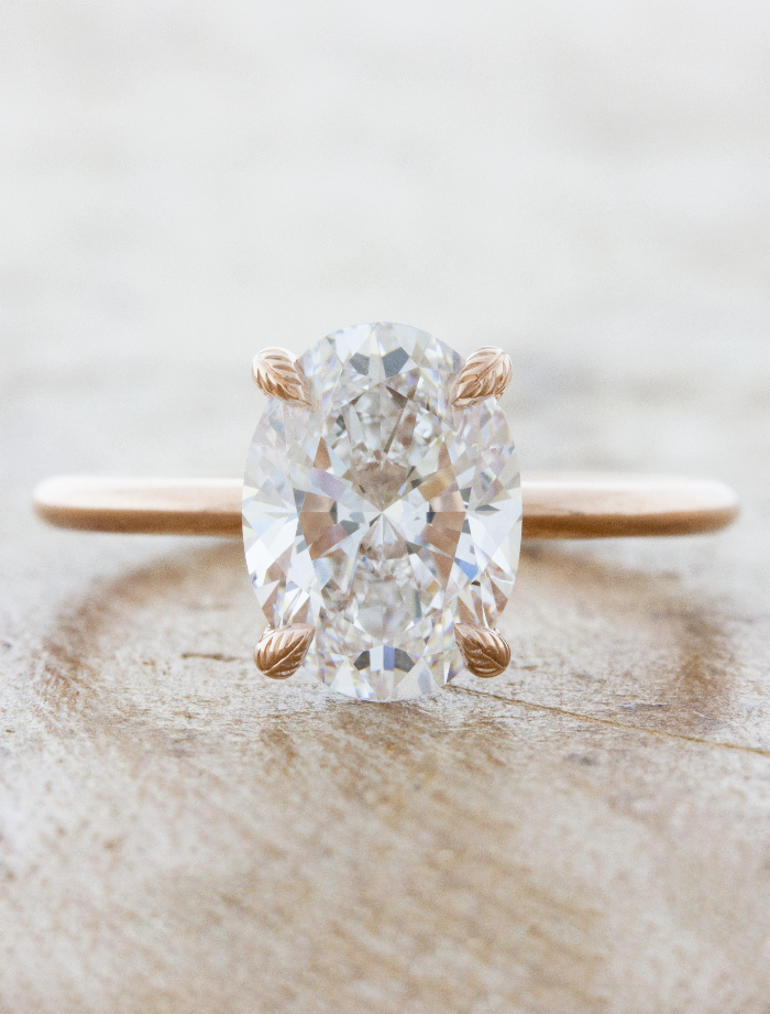 caption:Shown with 2.50ct oval in 14k rose gold with leaf prongs