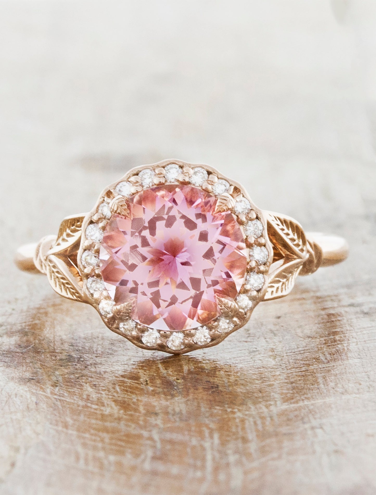 caption:Customized with round pink sapphire & custom halo in 14k rose gold