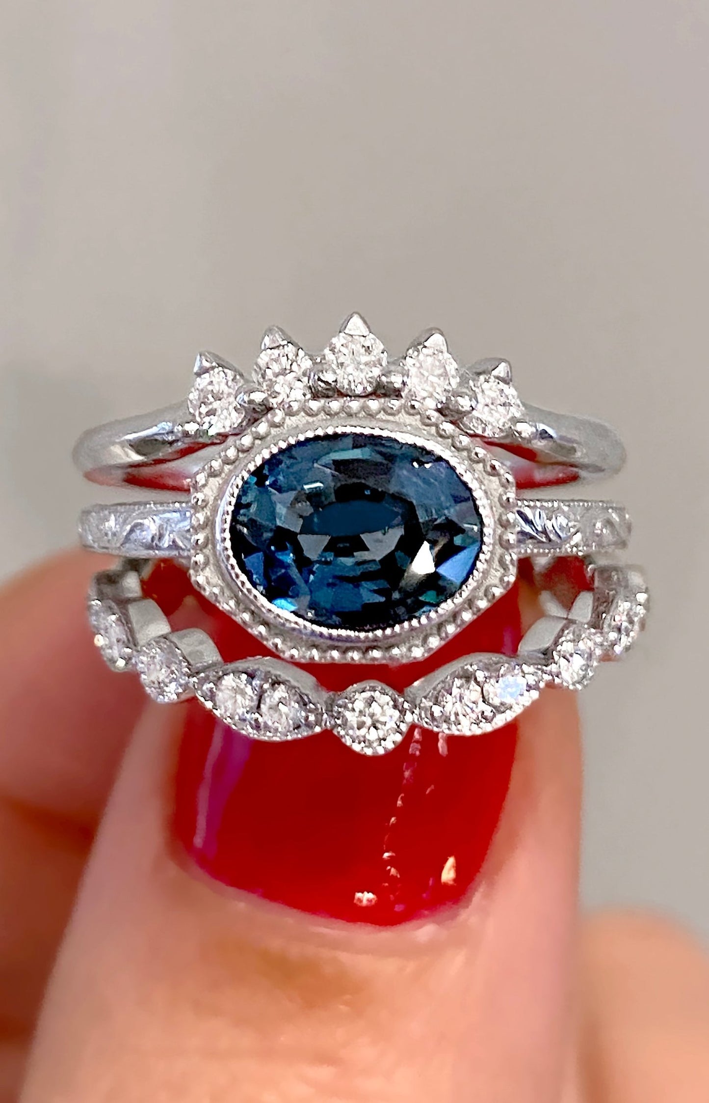 caption:Shown with blue sapphire, stacked with Antoinette & Salli wedding bands