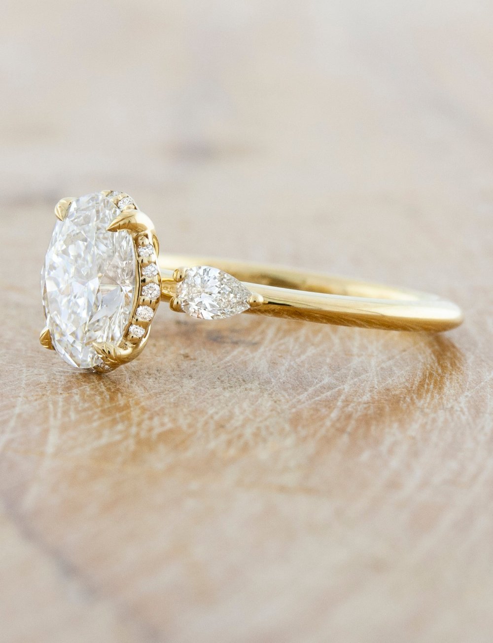 Oval diamond ring with store pear side stones