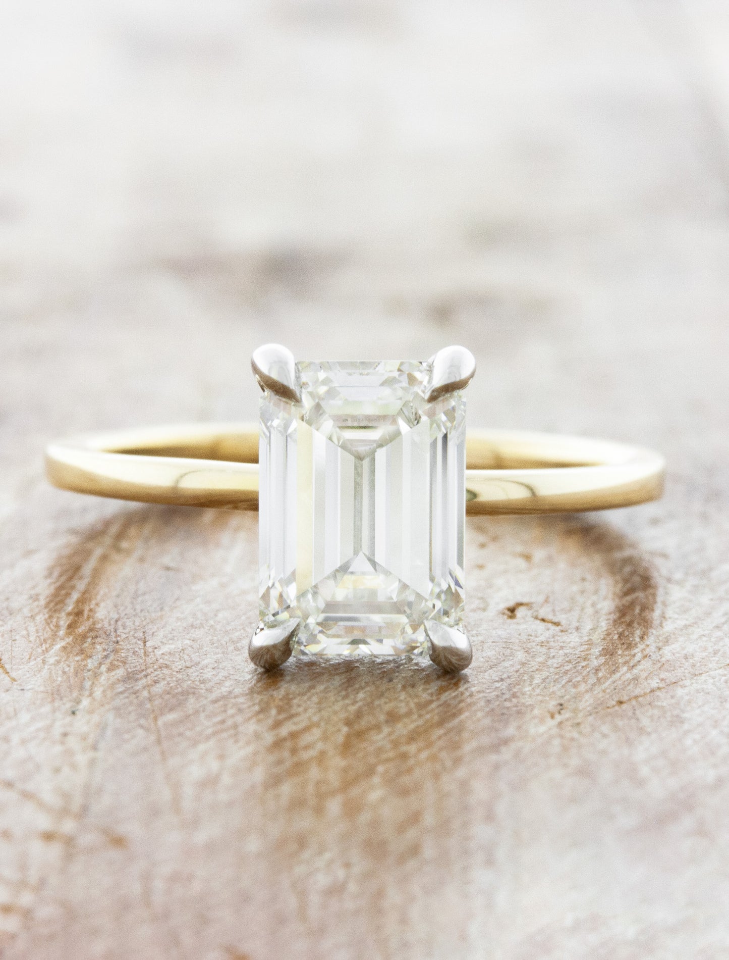 caption:Shown with 2.20ct emerald cut diamond in mixed platinum & 14k yellow gold setting