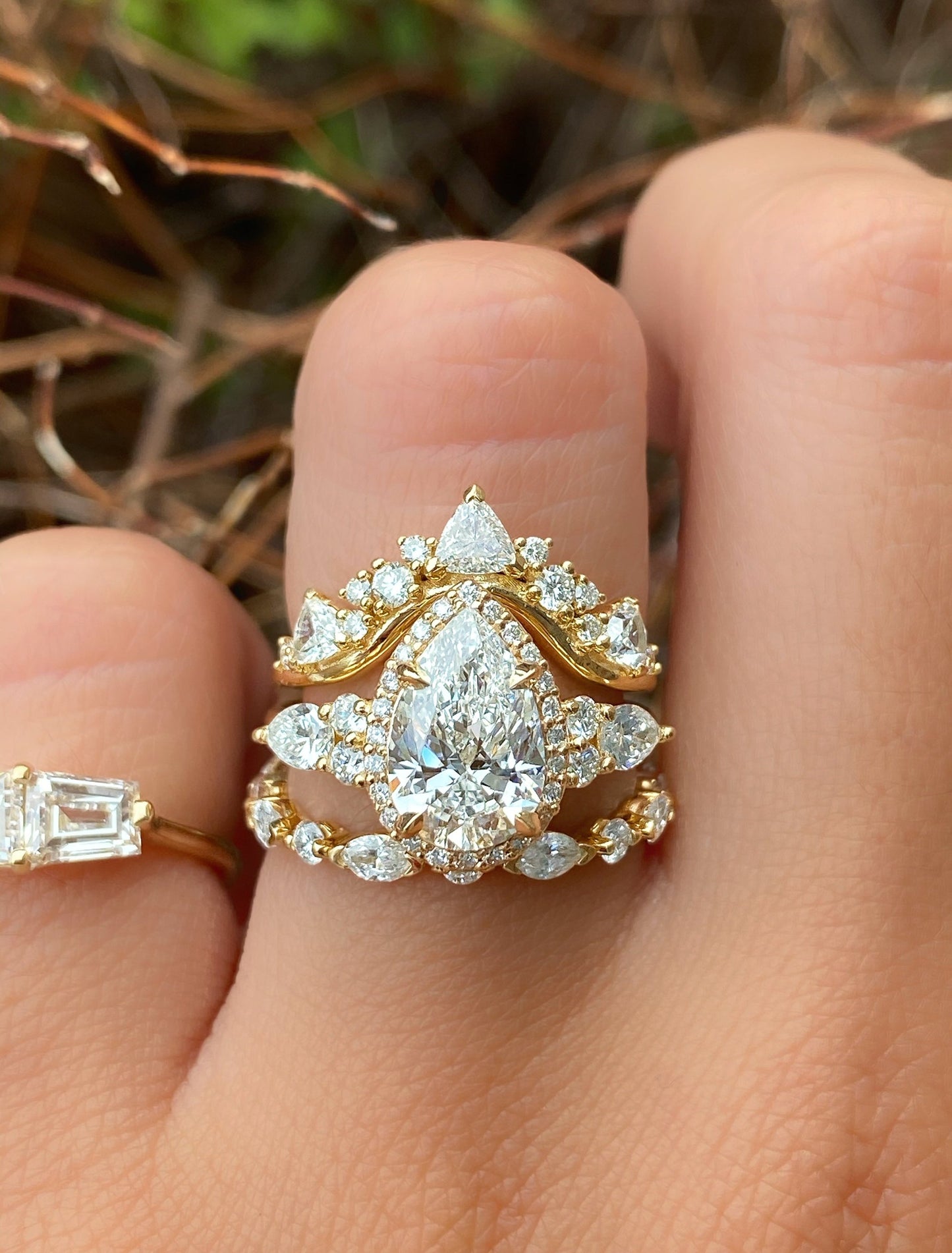 caption:Customized with pear diamond, stacked with Tempest & Sarah wedding bands