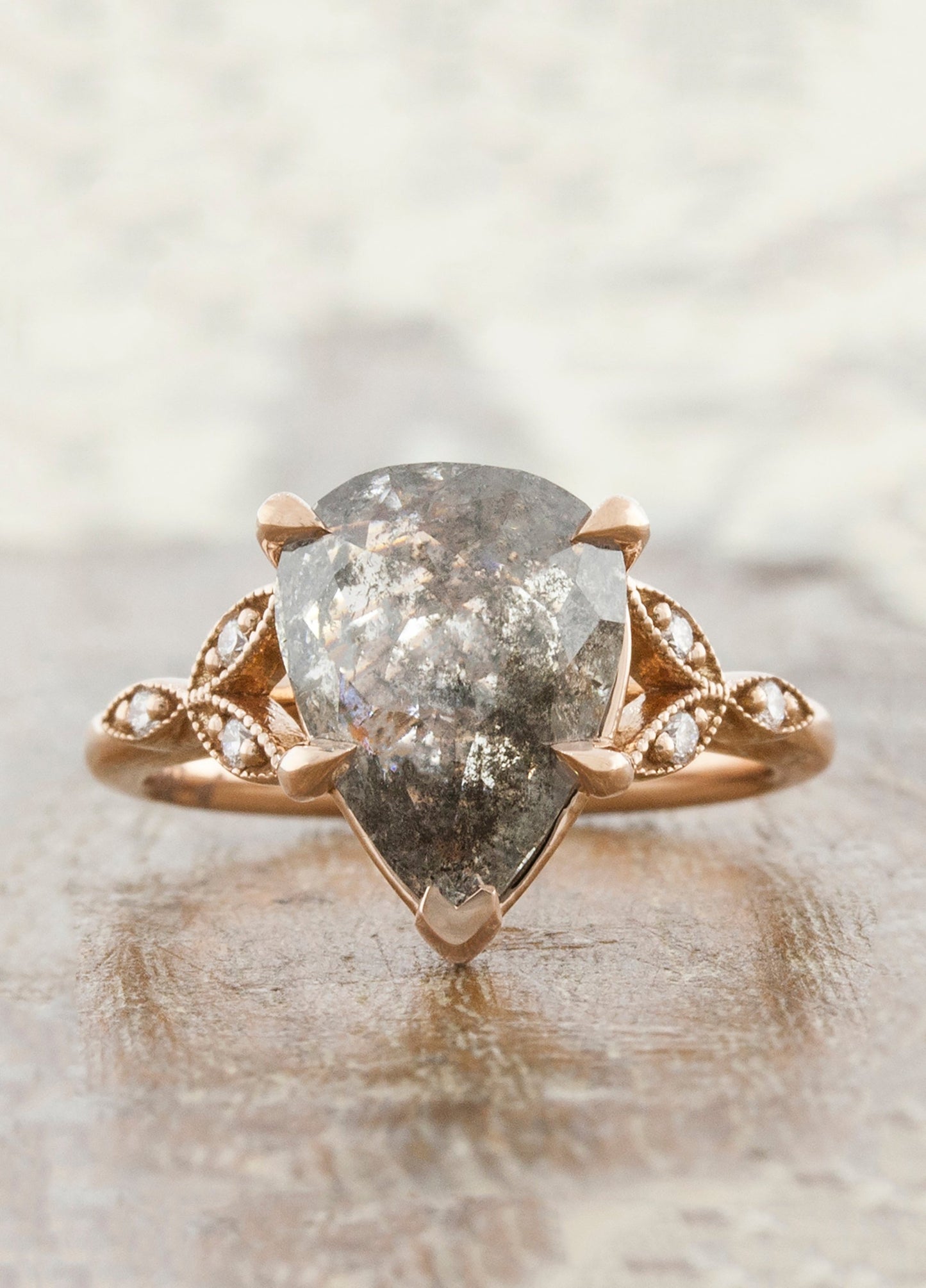 caption:Customized with a pear shaped salt & pepper diamond