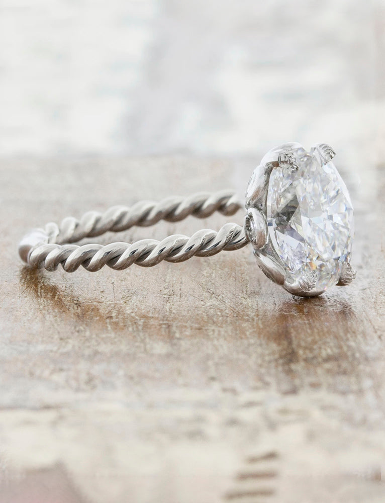 Oval diamond with twisted outlet band