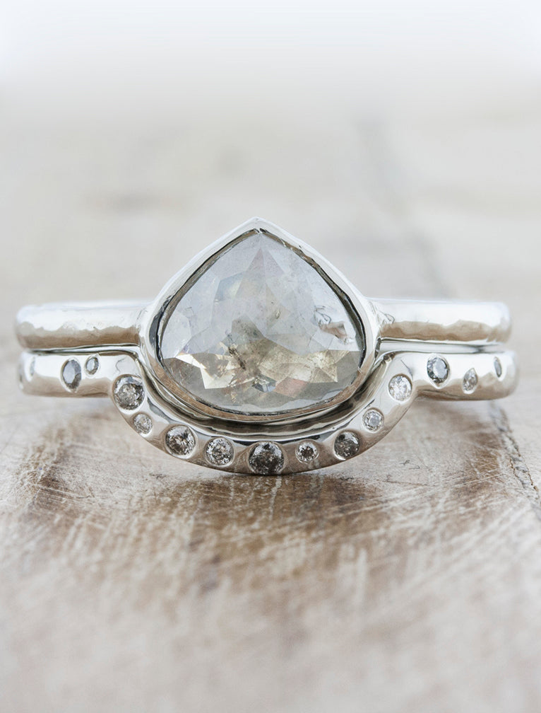 caption:Customized with 2.30ct rustic pear diamond in platinum, paired with custom Lula wedding band