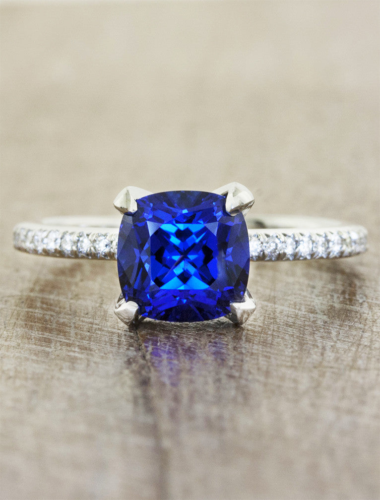 caption:Shown with cushion cut sapphire in platinum