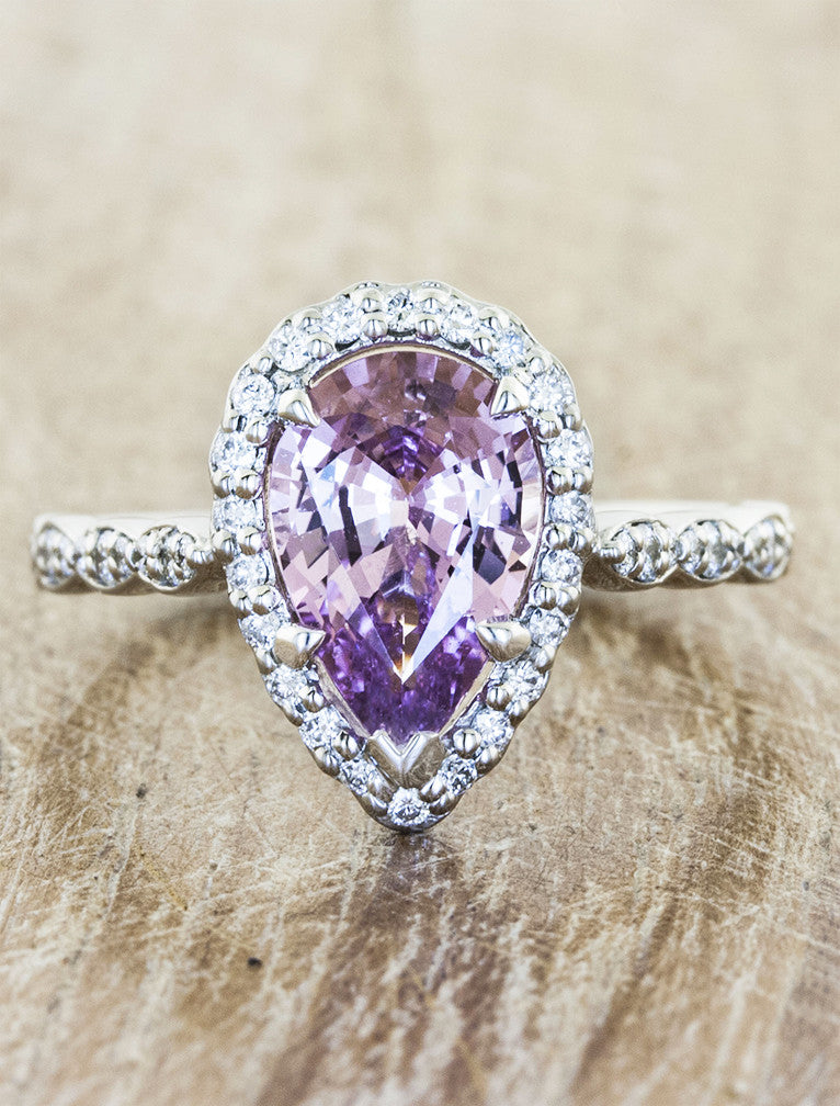 caption:customized in white gold with pink sapphire center