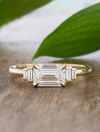 caption:Custom east-west orientation and thinner band, 1.2ct emerald cut