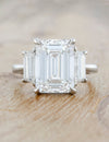caption:Shown with 5ct emerald cut diamond in platinum