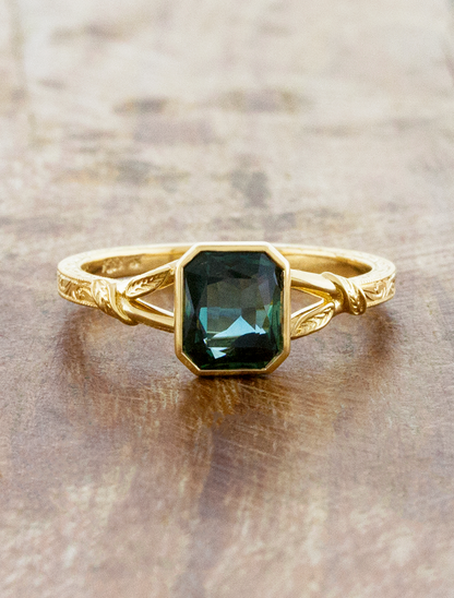 caption:Shown with 1.5ct emerald cut sapphire in 18k yellow gold 