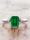 caption:Customized with 1.2ct emerald cut emerald in platinum