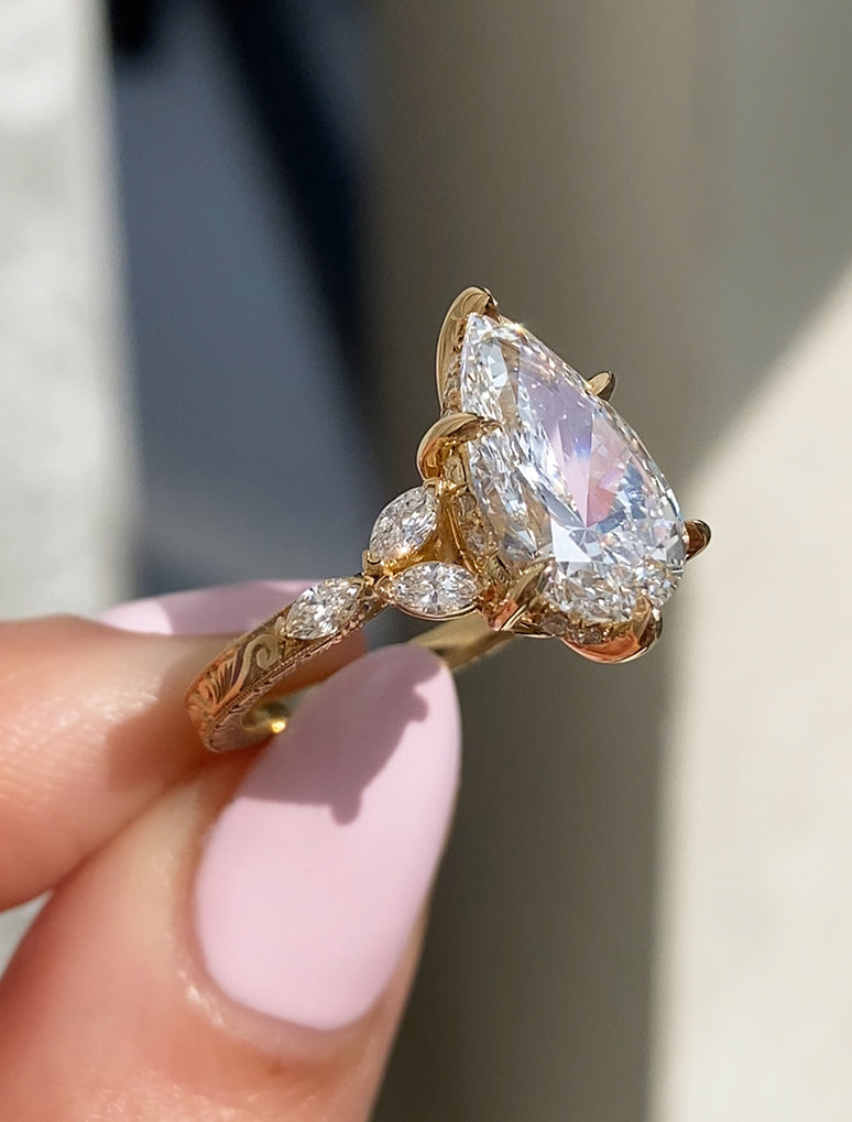 caption:Shown with 3ct pear in 18k yellow gold