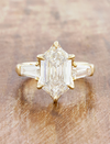 caption:Shown with 3ct elongated hexagon in 14k yellow gold 