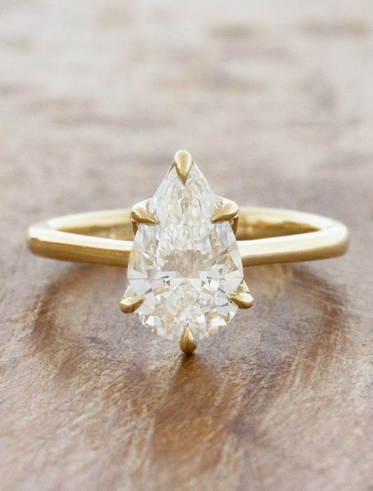 caption:Shown with 2.2ct pear diamond in 14k yellow gold
