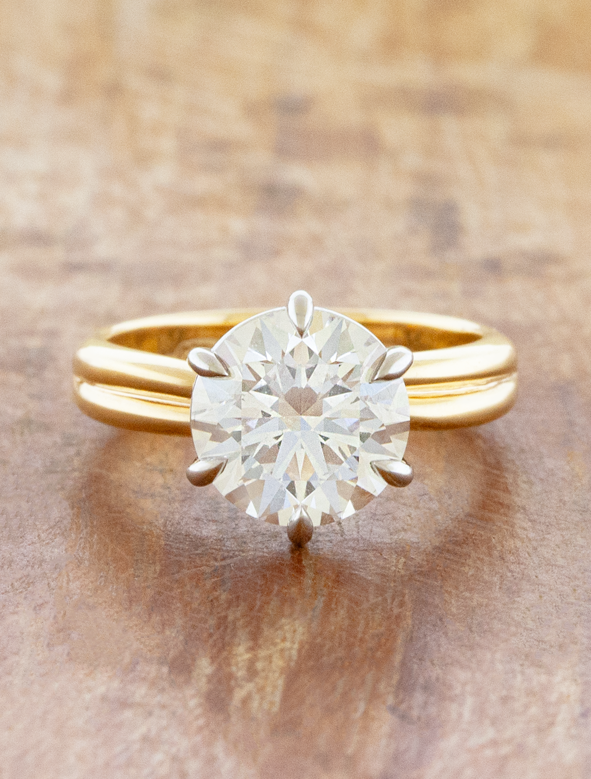 caption:Shown with 3ct round, 14 yellow gold band and platinum basket