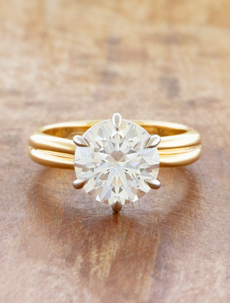 caption:Shown with 3ct round, 14 yellow gold band and platinum basket