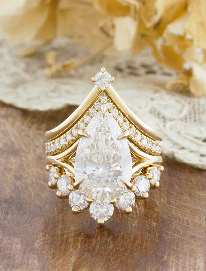 caption:Shown with 4ct pear, stacked with Kiana, Alexia and Antoinette Large