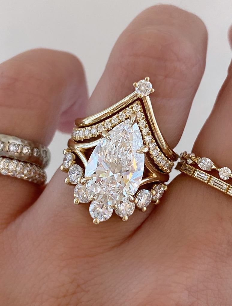 caption:Shown with 4ct pear, stacked with Kiana, Alexia and Antoinette Large