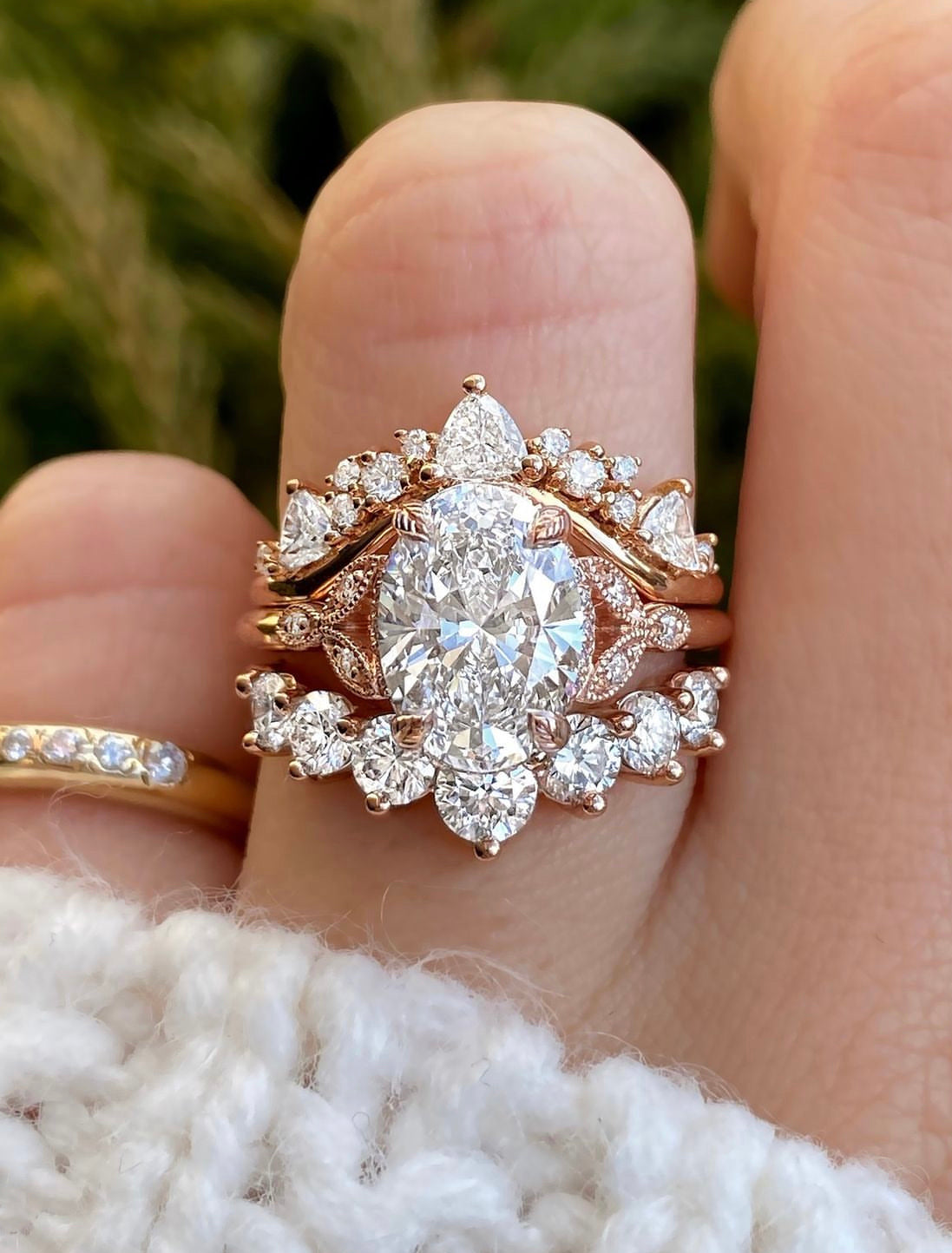 caption:2.25ct oval diamond in rose gold paired with Tempest and Antoinette Large wedding bands