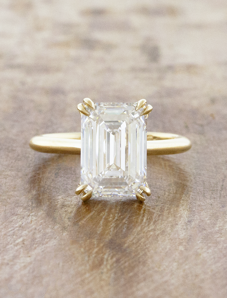 caption:Shown with 3ct emerald cut in 14k yellow gold 