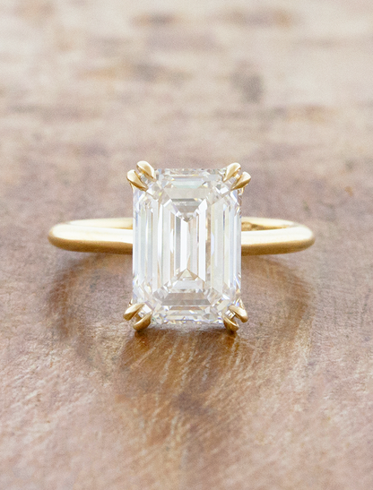 caption:Shown with 3ct emerald cut in 14k yellow gold 