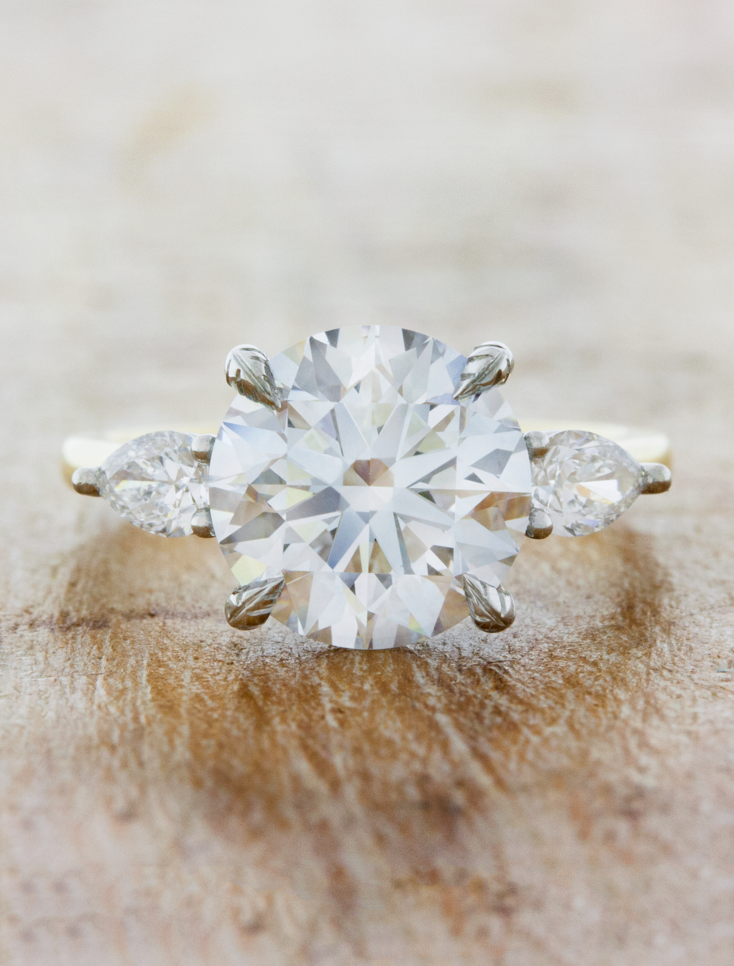 caption:Shown with 3ct round diamond & leaf prongs