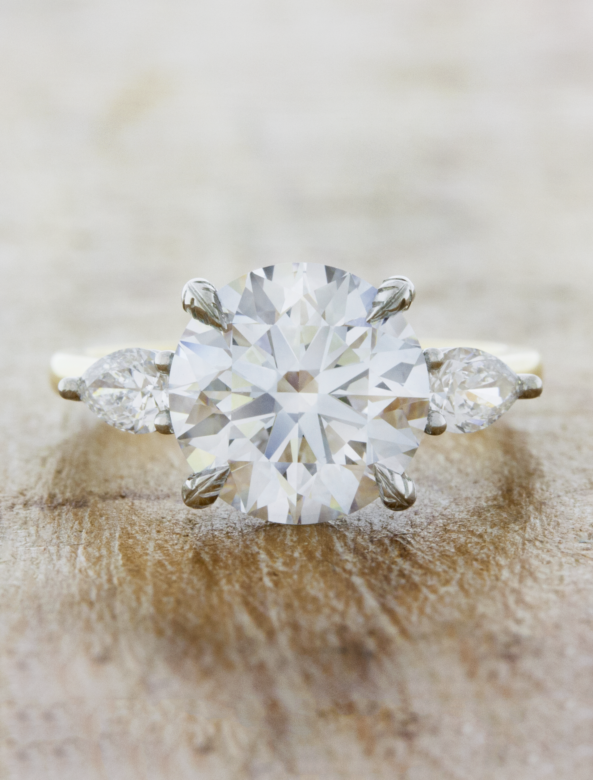 caption:Shown with 3ct round diamond & leaf prongs