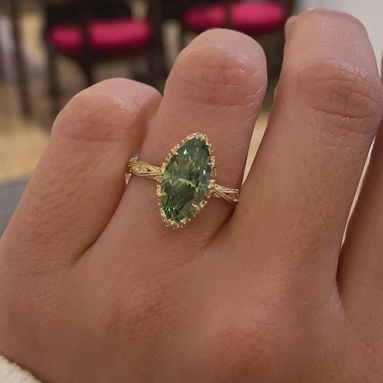 caption:Shown with 2.5ct fancy green marquise in 14k yellow gold 