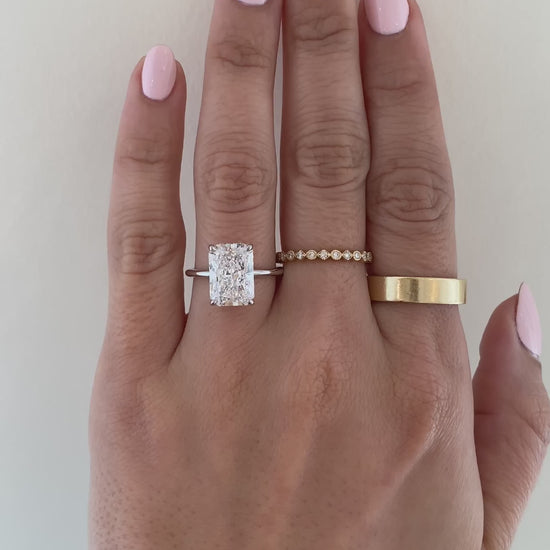 caption:Shown with 4.25ct radiant cut in platinum