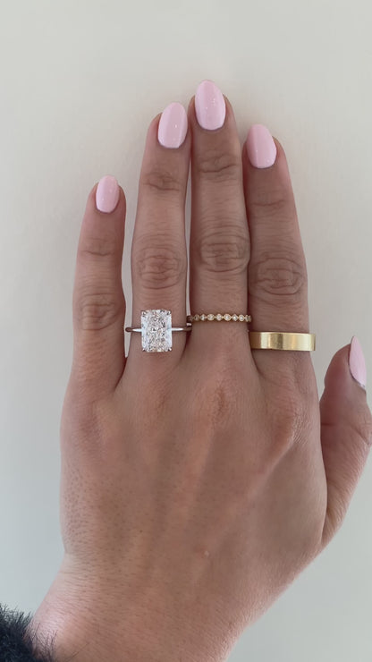 caption:Shown with 4.25ct radiant cut in platinum