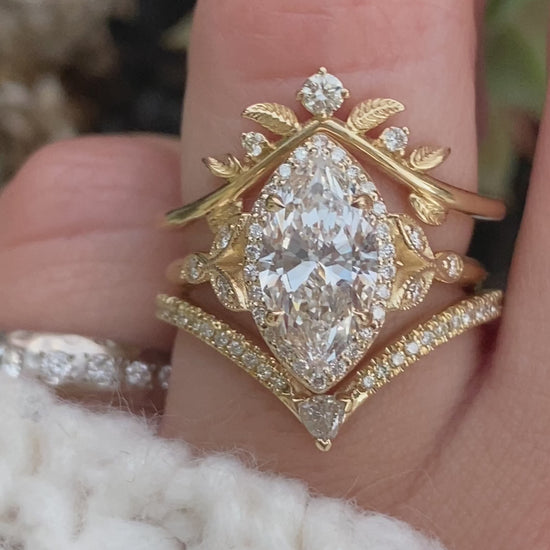 caption:Shown in a custom curve, paired with Rachael - Marquise engagement ring and Kia wedding band