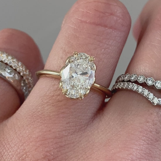 caption:Shown with 2ct oval cut diamond set in yellow gold setting