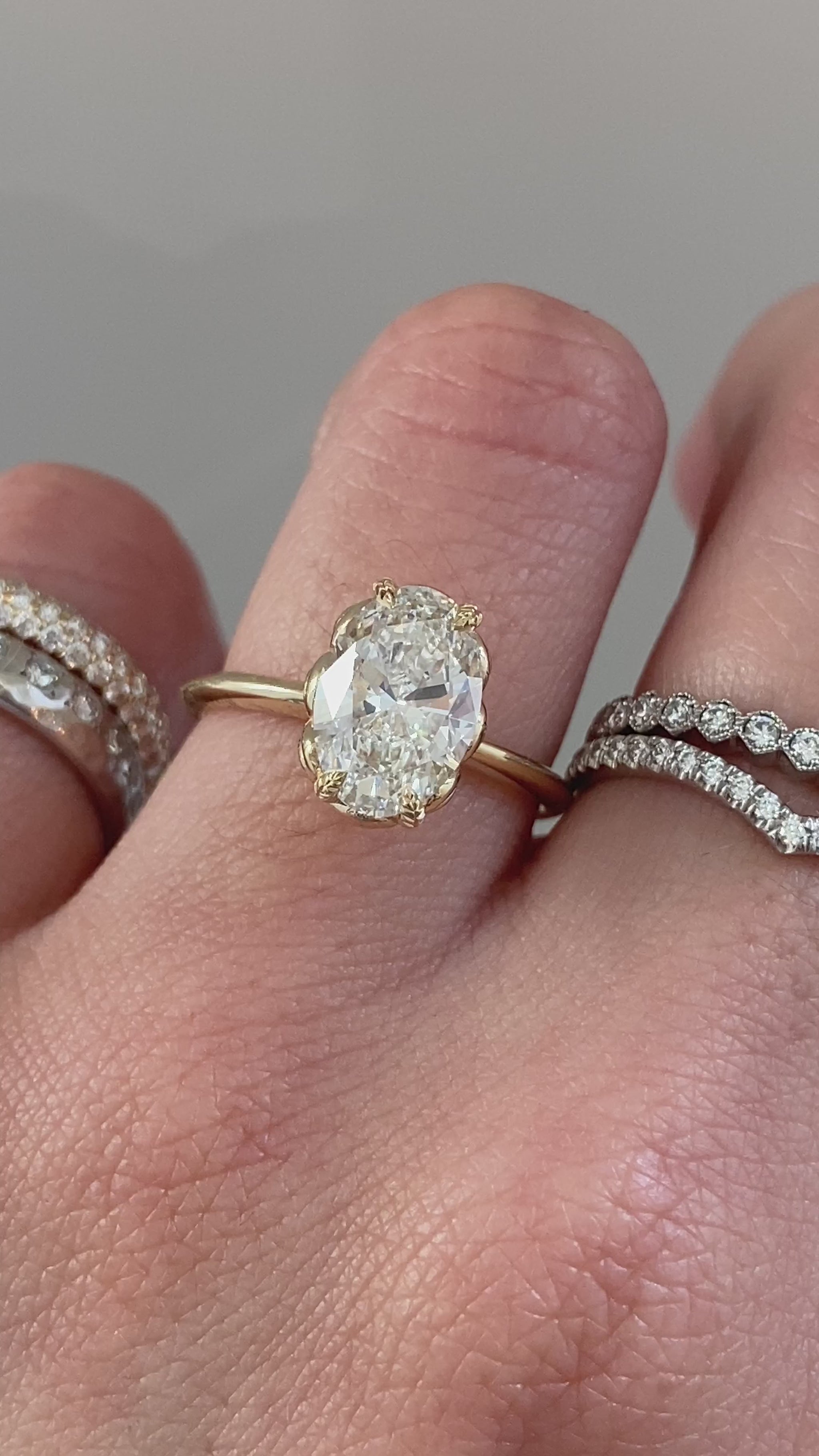 caption:Shown with 2ct oval cut diamond set in yellow gold setting