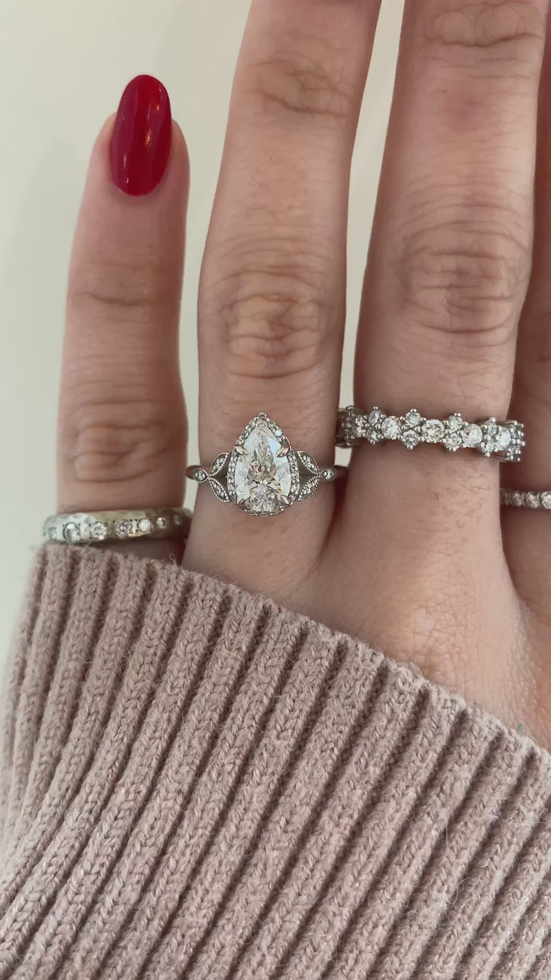 caption:Shown with 1.04ct pear diamond in platinum
