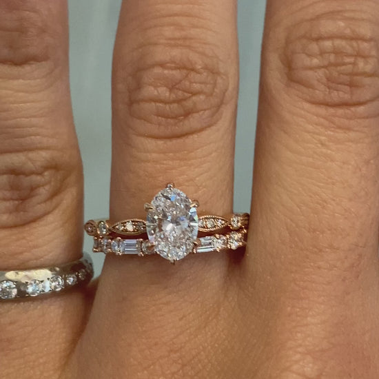caption:Shown with 1.20ct oval diamond.  Styled with Leah wedding band.