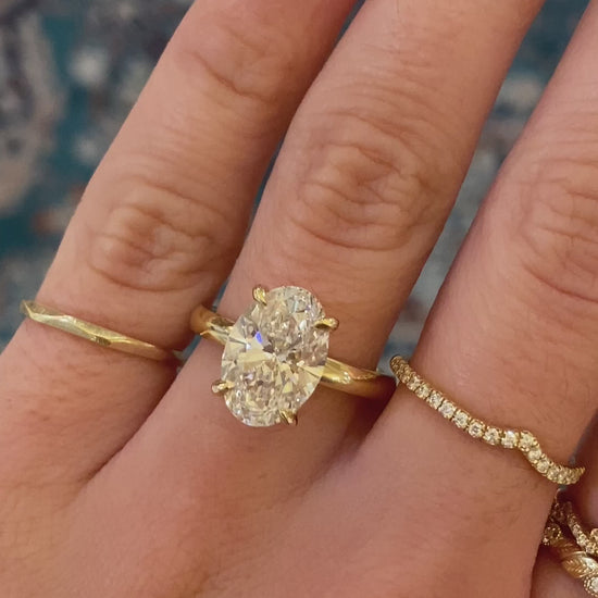 caption:Shown with oval cut diamond set in yellow gold