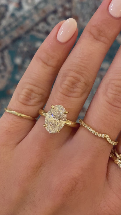 caption:Shown with oval cut diamond set in yellow gold