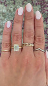 caption:Shown with 4ct emerald cut diamond in 14k yellow gold, customized with leaf engraved prongs