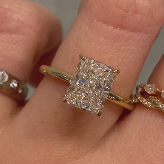 caption:Shown with radiant cut diamond set in yellow gold