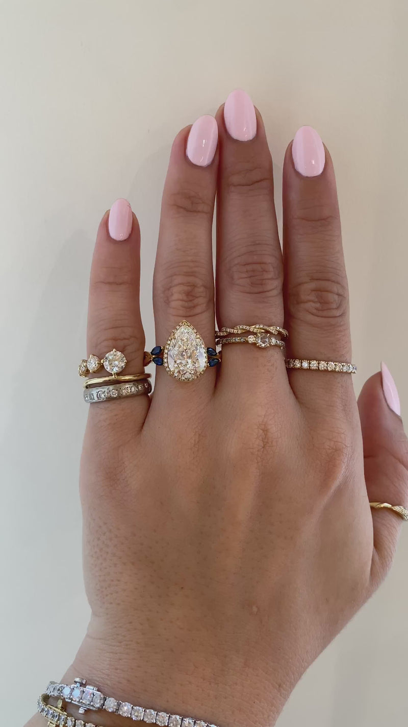 caption:Shown with 4.2ct pear diamond in yellow gold
