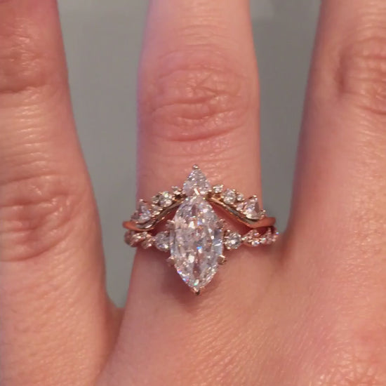 caption:Shown with marquise cut diamond paired with Tempest wedding band