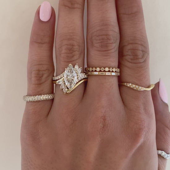 caption:Shown with 2.2ct marquise diamond in 14k yellow gold, stacked with Flirty wedding band