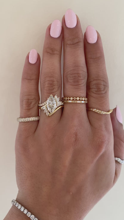 caption:Shown with 2.2ct marquise diamond in 14k yellow gold, stacked with Flirty wedding band