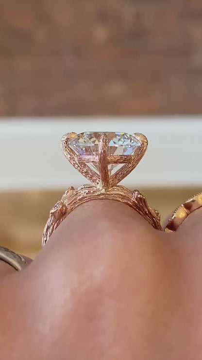 caption:Shown with 5ct round diamond set in rose gold