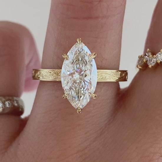 caption:Shown with 2ct marquise in 14k yellow gold 