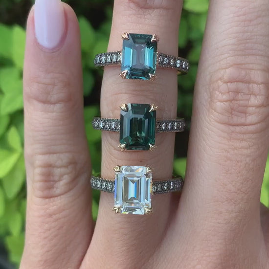 caption:Shown with emerald cut sapphires and diamond center stones