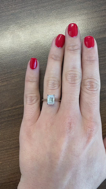 caption:Shown with 2ct emerald diamond set in platinum